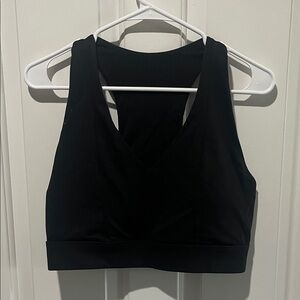 Fabletics black sports bra with opening on back and pocket for phone